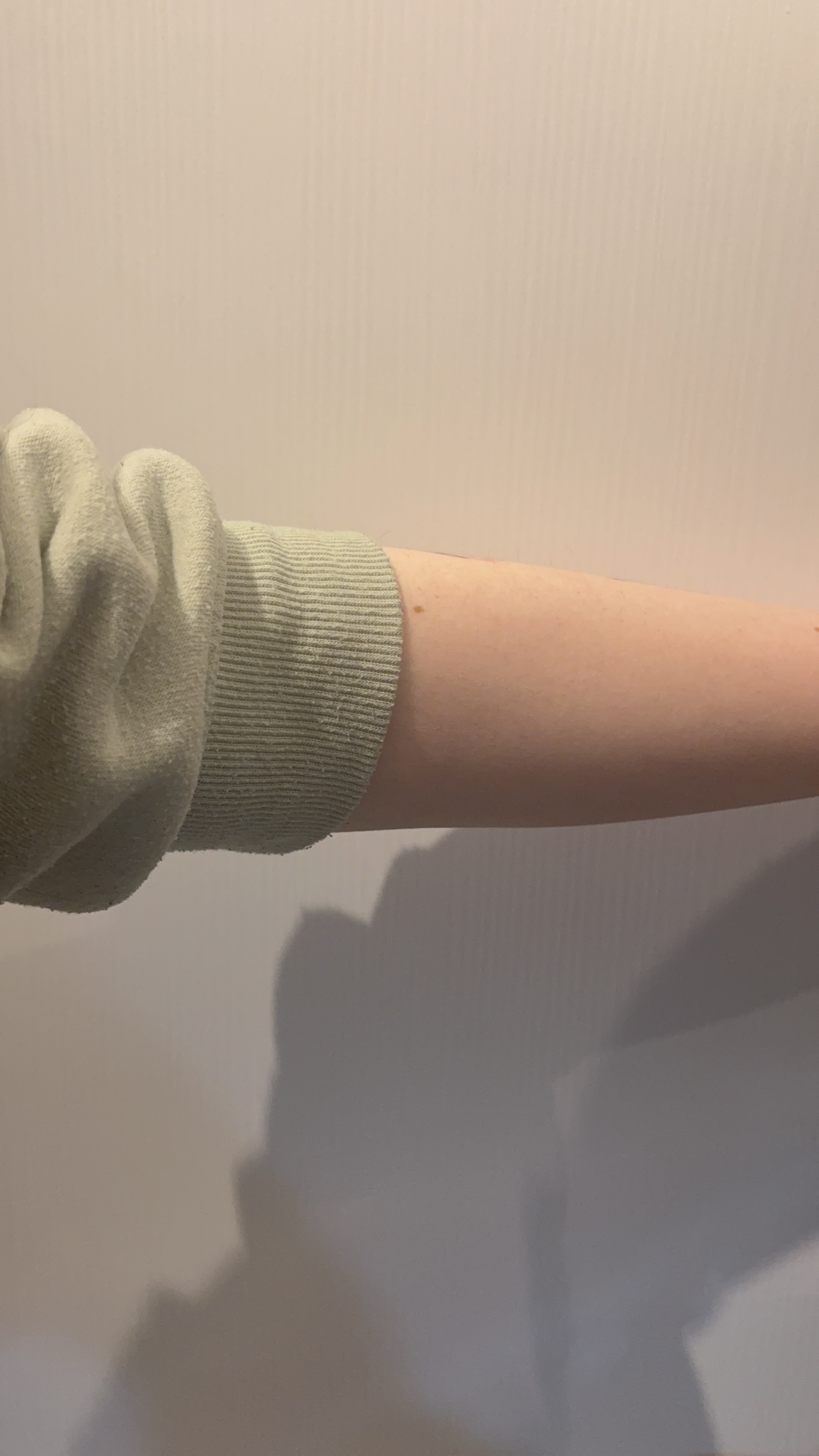 Rolling up a sleeve, a clothing-based interaction.