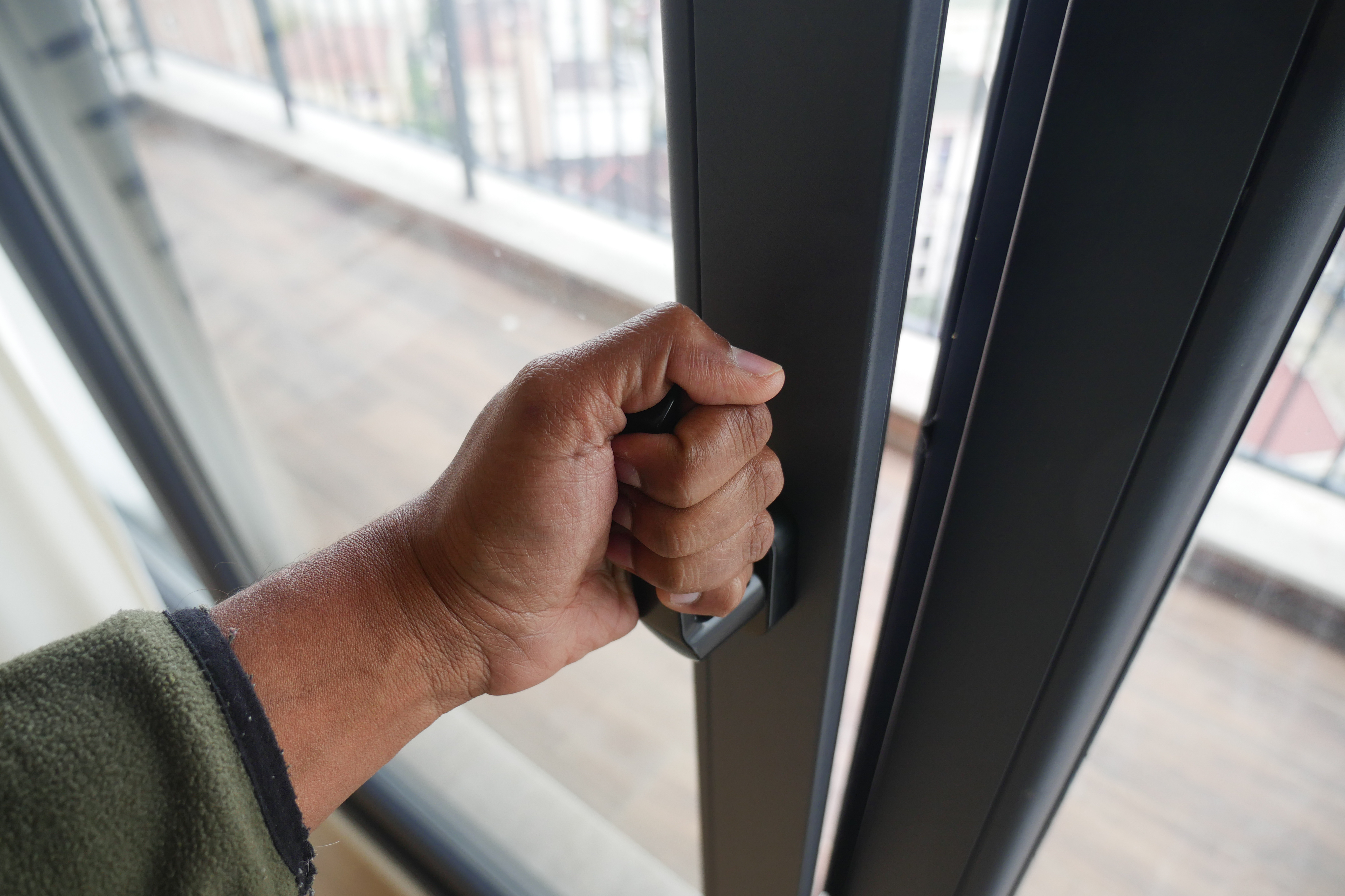 Opening a sliding door to the outside.